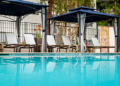 Thumbnail 19 of 36 - Pool, cabana and chaise lounge chairs at 55+ FountainGlen Goldenwest, Westminster, CA