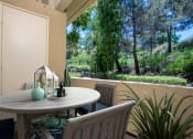 Thumbnail 9 of 27 - a patio with a white table and chairs at 55+ FountainGlen Laguna Niguel, California
