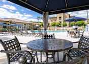 Thumbnail 9 of 22 - Seating area at pool of FountainGlen Stevenson Ranch