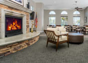 Thumbnail 19 of 34 - a room with a fireplace and a table and chairs at 55+ FountainGlen Valencia, California