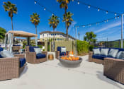 Thumbnail 12 of 34 - the outdoor patio has a fire pit and seating around it at 55+ FountainGlen Valencia, Valencia
