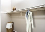 Thumbnail 5 of 34 - a walk in closet with a white robe hanging on a rail and a white towel at 55+ FountainGlen Valencia, Valencia