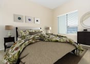 Thumbnail 4 of 34 - a bedroom with a bed and a dresser and a window at 55+ FountainGlen Valencia, California, 91354