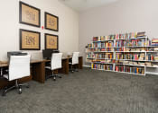 Thumbnail 23 of 34 - a library with desks and chairs and bookshelves at 55+ FountainGlen Valencia, California