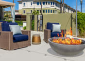 Thumbnail 11 of 34 - pool area chairs and a fire pit at 55+ FountainGlen Valencia, California