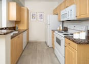 Thumbnail 2 of 28 - Modern kitchen with wooden cabinets setup at 55+ FountainGlen Grand Isle, California, 92562