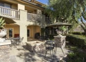Thumbnail 14 of 25 - a patio with tables and chairs and a fire pit at 55+ Remington at Ladera Ranch, Ladera Ranch, CA