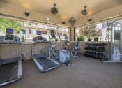 Thumbnail 12 of 46 - a fitness center with treadmills and other exercise equipment