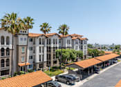 Thumbnail 32 of 34 - A row of apartment buildings with a parking lot in front. at 55+ FountainGlen Terra Vista, California