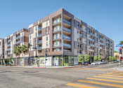 Thumbnail 21 of 26 - A modern apartment building with a street view in front at Wilshire Valencia Apartment, Los Angeles, CA, 90017