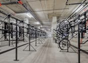 Thumbnail 14 of 26 - A long hallway with bicycles on stands at Wilshire Valencia Apartment, Los Angeles, California