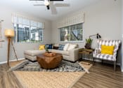 Thumbnail 7 of 62 - Living room with a wooden coffee table at The Grove Apartments, California, 91761