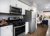 Thumbnail 10 of 62 - Modern kitchen at The Grove Apartments, Ontario, California