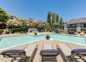 Thumbnail 4 of 28 - our apartments offer a swimming pool with tables and chairs at Harbor Pointe, California, 92629