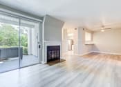 Thumbnail 11 of 28 - an empty living room with a fireplace and a sliding glass door at Harbor Pointe, California