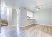 Thumbnail 12 of 28 - an empty living room and kitchen with hard wood floors at Harbor Pointe, California