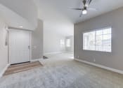 Thumbnail 21 of 28 - an empty living room with a white door and a ceiling fan at Harbor Pointe, Dana Point, CA