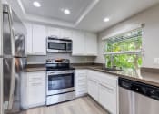 Thumbnail 23 of 28 - a kitchen with white cabinets and stainless steel appliances at Harbor Pointe, Dana Point, CA, 92629