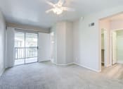 Thumbnail 27 of 28 - an empty living room with a ceiling fan and a door to a balcony at Harbor Pointe, Dana Point, CA, 92629