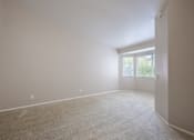 Thumbnail 36 of 45 - A room with a carpeted floor and a door leading to a balcony.