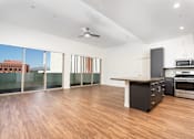 Thumbnail 11 of 68 - Penthouse with kitchen, wood style flooring and large windows at Imperial Hardware Lofts, Riverside