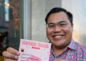 Thumbnail 34 of 68 - Man holding pink menu card. at Imperial Hardware Lofts, California