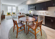 Thumbnail 1 of 83 - Eat-In Kitchen With Dining Room Table, Black Cabinets, White Countertops, And Stainless-Steel Appliances. at Bayswater Apartments, Burlingame, 94010