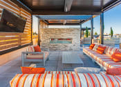 Thumbnail 32 of 83 - Rooftop lounge seating with TV and fireplace at Bayswater Apartments, California