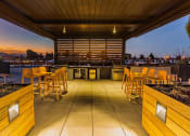 Thumbnail 36 of 83 - Rooftop Grill Area With Wood-Style Seating, City Views, And Gazebo-Style Covering. at Bayswater Apartments, Burlingame, 94010