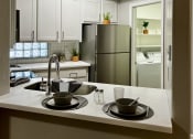 Thumbnail 16 of 18 - kitchen with white cabinets and stainless steal refirgerator