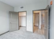 Thumbnail 48 of 83 - Bedroom with walk in closet and door to living room at Bayswater Apartments, California