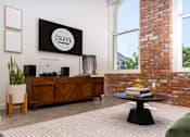 Thumbnail 40 of 68 - a living room with a brick wall and a large window at Imperial Hardware Lofts, Riverside