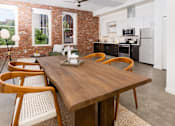 Thumbnail 49 of 68 - a dining room and kitchen with a wooden table and chairs at Imperial Hardware Lofts, California
