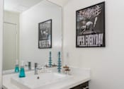 Thumbnail 60 of 68 - a white bathroom with a sink and a mirror at Imperial Hardware Lofts, Riverside, 92501