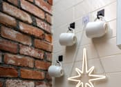 Thumbnail 61 of 68 - a christmas ornament hanging from a brick wall next to a table with a candle at Imperial Hardware Lofts, California, 92501