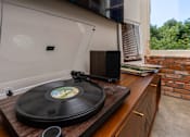 Thumbnail 64 of 68 - a vinyl record on a record player in a room with a window at Imperial Hardware Lofts, Riverside