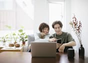 Thumbnail 15 of 80 - two people sitting at a table looking at a laptop