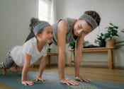 Thumbnail 18 of 123 - mother and daughter doing yoga at home