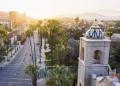 Thumbnail 46 of 52 - a view of a city street with palm trees and a building with a blue and at North Grove, Riverside, CA  