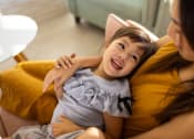 Thumbnail 12 of 72 - a young girl laying on a couch with her mother