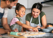 Thumbnail 47 of 52 - a mother and father making cookies with their daughter in the kitchen at North Grove, Riverside, 92501  