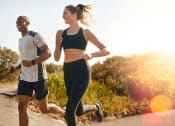 Thumbnail 11 of 60 - a man and a woman running on a road