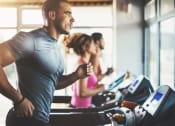Thumbnail 73 of 75 - a man running on a treadmill in a gym