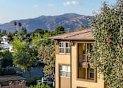 Thumbnail 79 of 80 - A building with a mountain in the background.