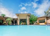 Thumbnail 1 of 80 - a swimming pool with a building in the background
