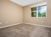 Thumbnail 24 of 80 - a bedroom with carpet and a large window
