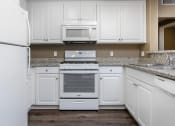 Thumbnail 31 of 80 - a kitchen with white cabinets and white appliances
