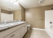 Thumbnail 30 of 80 - a bathroom with a toilet sink and bathtub