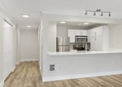 Thumbnail 34 of 73 - a kitchen with white cabinetry and a white counter top and stainless appliances at Lakemont Orchard, Issaquah  