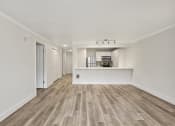 Thumbnail 37 of 73 - Living area with wood style flooring and kitchen in the background.at Lakemont Orchard, Issaquah, WA  